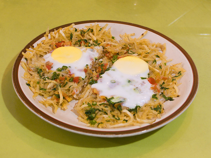 "Parsi food is so good, it’ll make you say ‘jamva chalo ji’ even if you just ate—because when it comes to bhonu, Bawas don’t do ‘small appetite’, dikra! It’s got eggs on everything, meat in every mood, and sugar sneaked in where you least expect it. You’ll smell ghee before you see the food—and hear ‘finish it, don’t waste’ before your first bite. Basically, if your plate isn’t full and your pants aren’t tight, are you even at a Parsi table?"